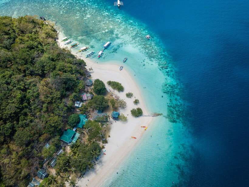 Coron: Coastal Cliffs, Beach & Malcapuya Island Hopping Tour - Stop 1 at Banana Island, Beach Time Without the Crowds