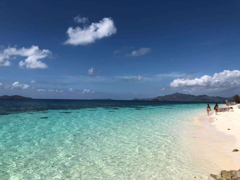 From Coron: Private Island-Hopping Cruise with Lunch - Stop 1: Malcapuya’s shallow southern beach and coral chances near seagrass