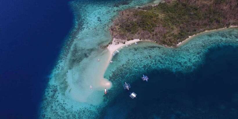 From Coron: Private Island-Hopping Cruise with Lunch - Stop 3: Banana Island’s curved fine sand and reef just off shore