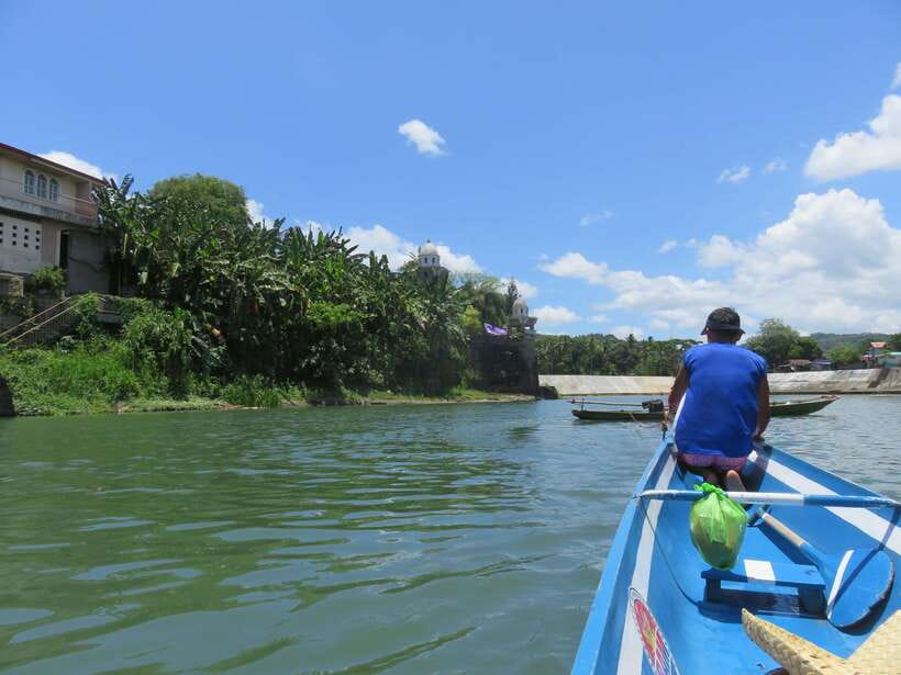 From Manila: Pagsanjan Falls Day Tour - Bamboo raft under Pagsanjan Falls, mist, and Devil’s Cave